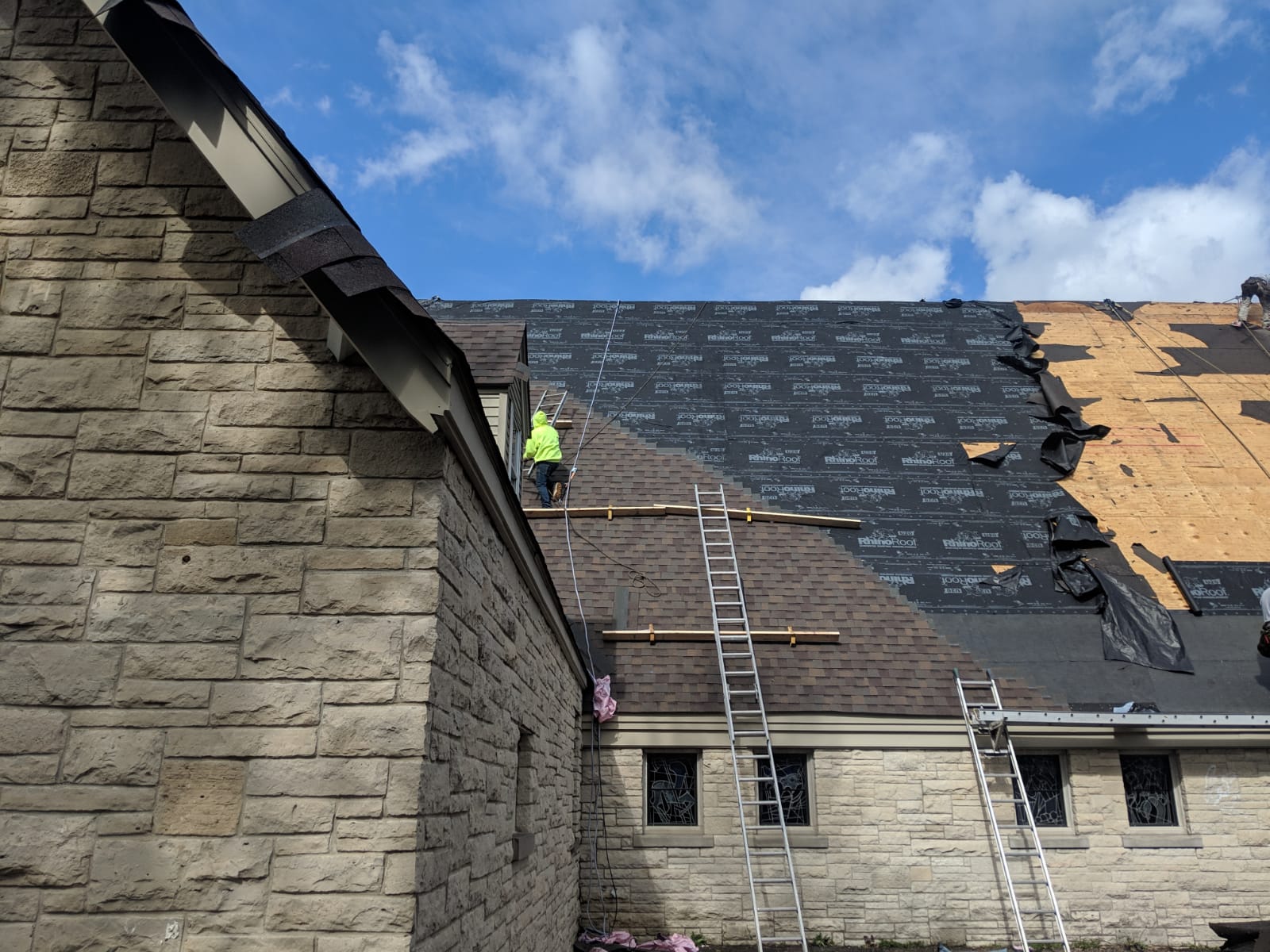 Historic stone church with stained glass windows — St. Paul church roofing by Midwest Building Exteriors